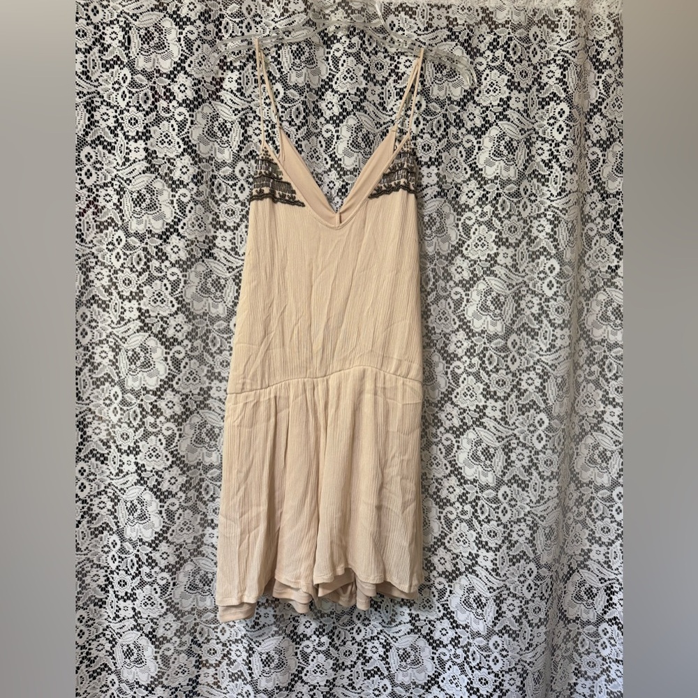 Cute tan romper size L with beading at the top. Great condition